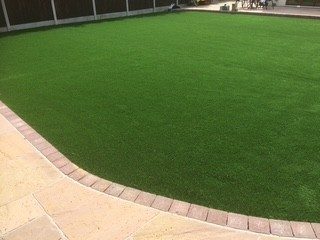 Large artificial lawn with block edging