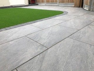 Curved porcelain patio with artificial grass