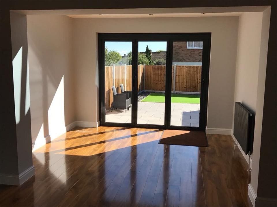 Extension interior with black bi-fold doors and wood floor