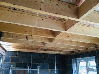 Roof structure: Timber joists set on the steel and wall plates.