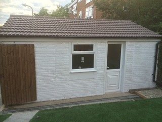 Converted garage with new tiled roof, window and door