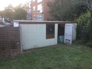 Old garage with flat roof before work began