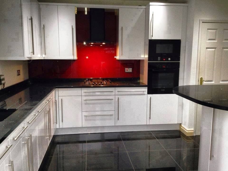 White gloss kitchen with red glass splashback