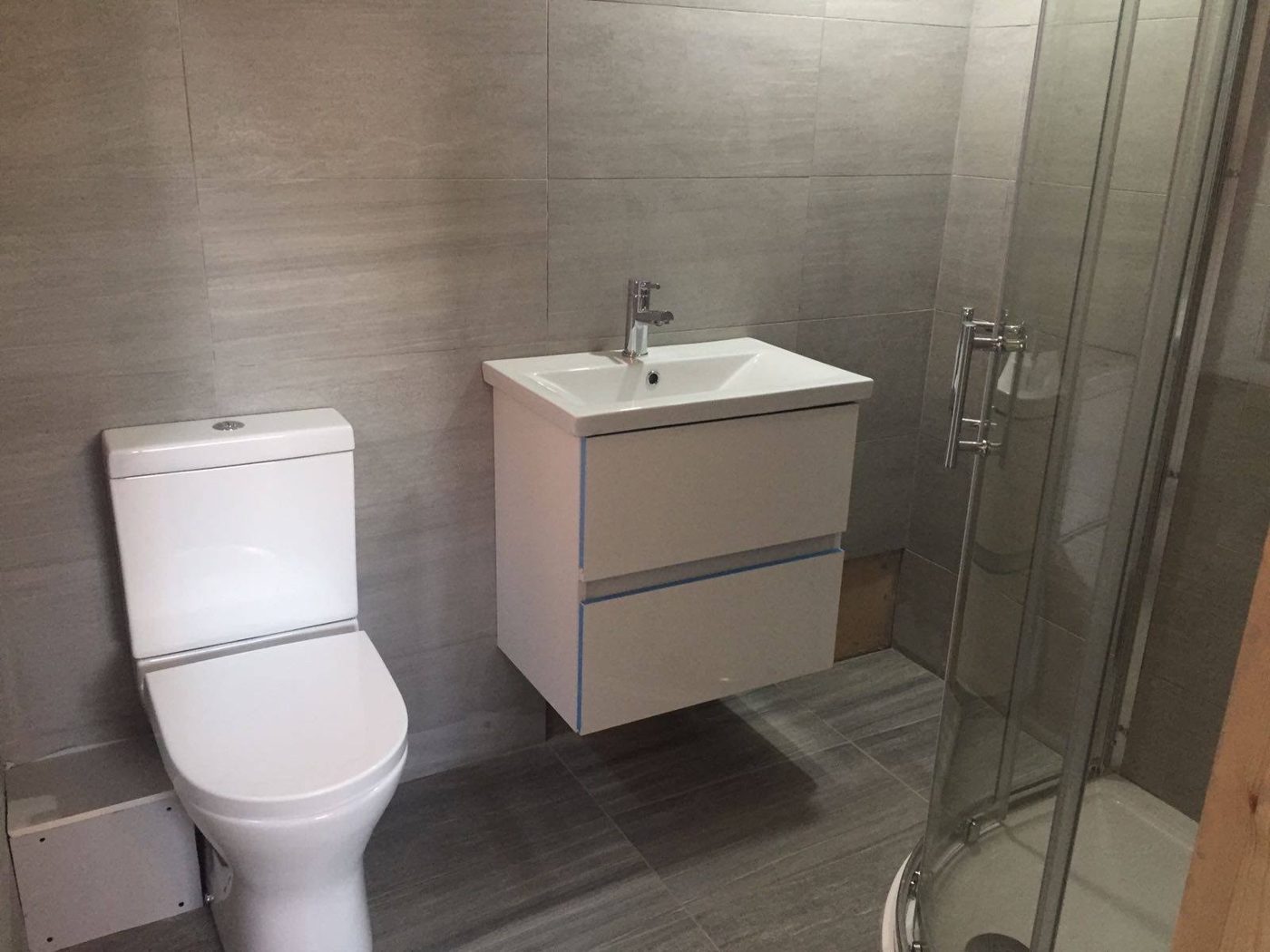 Shower room with wall-hung vanity and WC